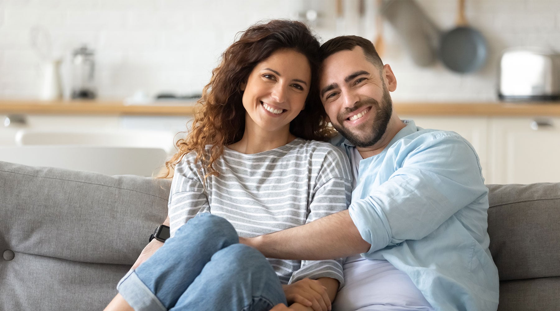 A couple sitting together at home after buying their house