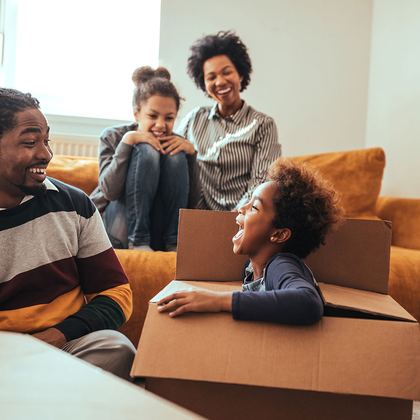 A family unpacking boxes in a new living room